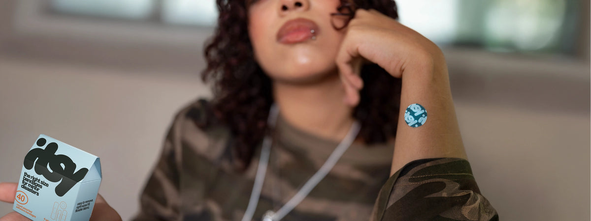 Young woman holding an itsy bandage box